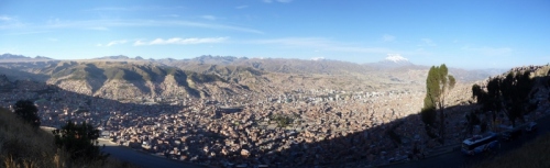 The city of La Paz lapping up the walls of its canyon, impressive snowy Illimani in the background
